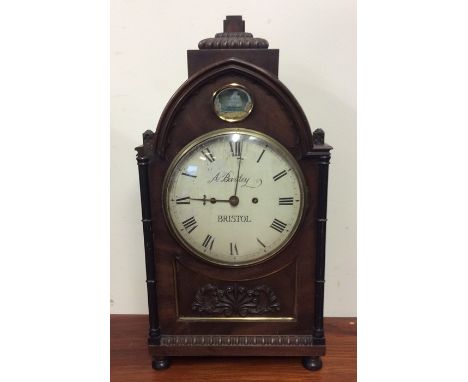 A good Georgian mahogany bracket clock with scroll decoration and white enamelled dial on four turned feet. By A Bartley of B