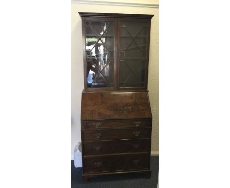 A good Georgian style mahogany bureau-bookcase with fitted interior on bracket feet. Est. £80 - £120.