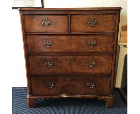 A fine early 18th Century style walnut veneered chest of five cock-beaded drawers with brass plate handles and escutcheon fla