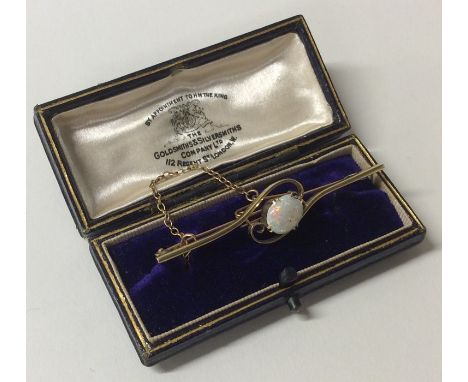 A good opal and gold brooch of swirl form to claw mount. Approx. 4.3 grams. Est. £120 - £150.