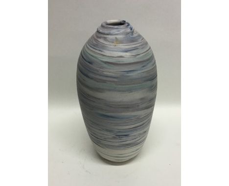 JAN TWYEROULD (Australian): A stylish baluster shaped ceramic pottery vase of blue swirl design on pedestal foot. Impressed '