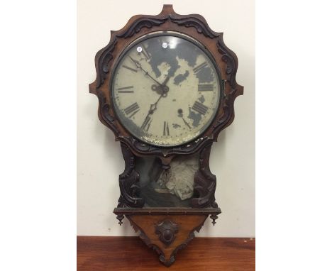 A Victorian mahogany mantle clock with scroll decoration. Est. £30 - £50.