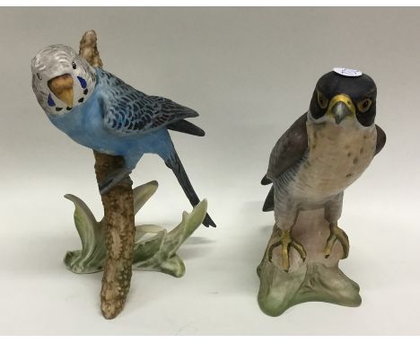 A Goebel figure of a kestrel together with another of a budgerigar. Est. £20 - £30.