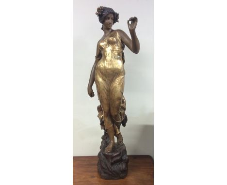 FRIEDRICH GOLDSCHEIDER:  A tall earthenware figure of a stylised lady wearing gold flowing dress on rugged base. Signed verso