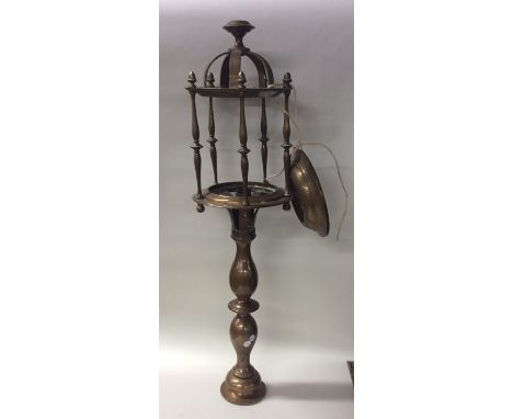 A tall brass marine lamp with shaped base. Approx. 65 cms high. Est. £150 - £250.