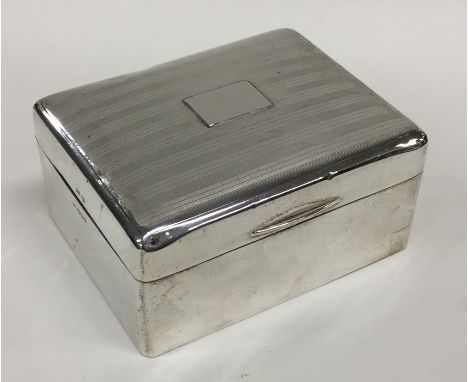 A heavy silver engine turned cigarette box with fitted interior. Approx. 434 grams. Est. £30 - £50.
