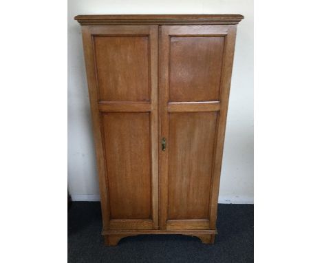 A mahogany two door cupboard on bracket feet. Est. £30 - £50.