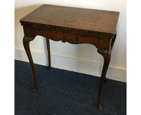 A Continental walnut hinged top card table on four cabriole legs. Est. £50 - £80.