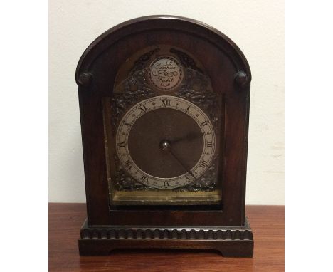 A Georgian style mahogany mantle clock with silvered dial. Est. £30 - £50.
