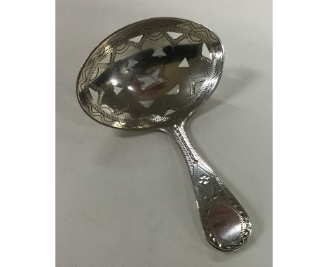 A Georgian silver pierced caddy spoon with bright cut decoration. London 1795. By George Barrows. Approx. 7.2 grams. Est. £10
