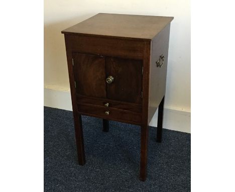 A Georgian mahogany two drawer commode on square feet. Est. £30 - £50.