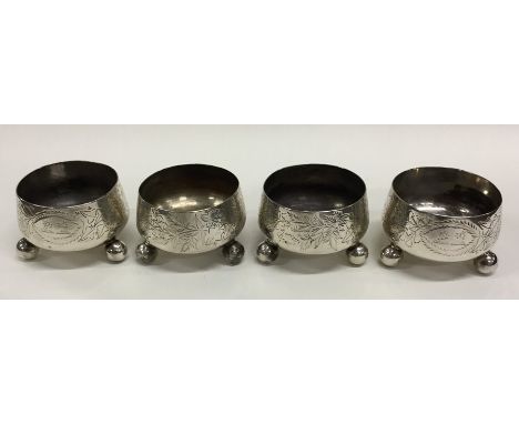 A heavy set of four Victorian silver salts on ball feet. London 1878. By William Hutton. Approx. 200 grams. Est. £150 - £200.