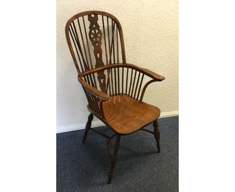 A large yew wood stick back Windsor chair of typical form. Est. £200 - £300.