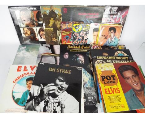 A collection of 7" and 12" vinyl records to include The Beatles, The Rolling Stones, David Bowie, Elvis and other (Paranoid i