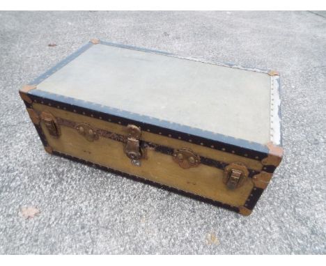 A vintage metal bound trunk by Watajoy, London, approximately 34 cm x 92 cm x 53 cm.