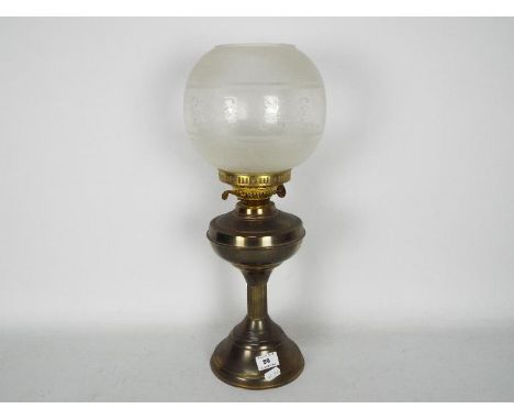 A vintage oil lamp with a height of 56 cm, includes glass chimney (not pictured)