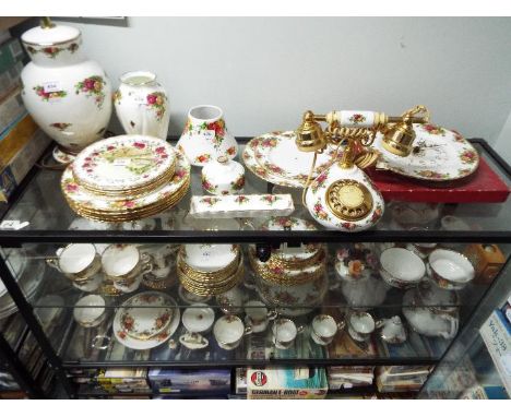 A large quantity of Royal Albert Old Country Roses dinner and tea wares to include plates, cups, saucers, vases, table lamp a