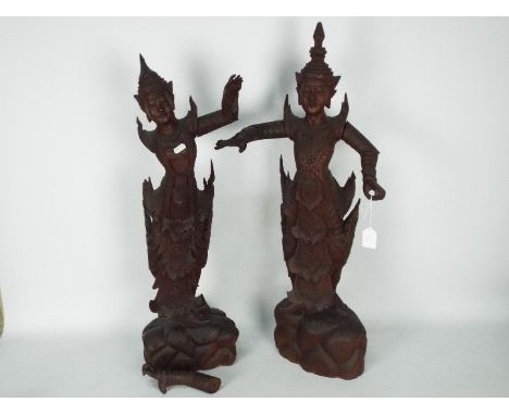 A large pair of South East Asian carved wood figures of female dancers, largest approximately 76 cm (h), one arm detached. [2