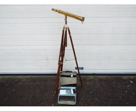 A brass telescope on wood and brass tripod and a vintage portable typewriter. [2]