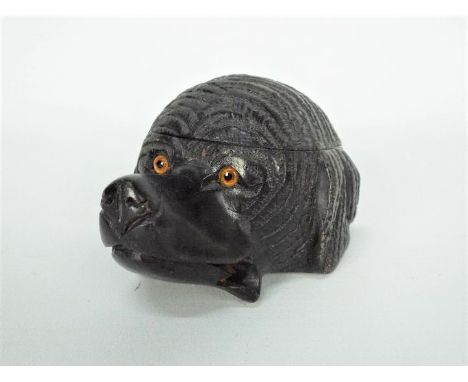 A black forest carved wood inkwell in the form of a dog's head with glass eyes and blue ceramic liner, 11 cm (l).