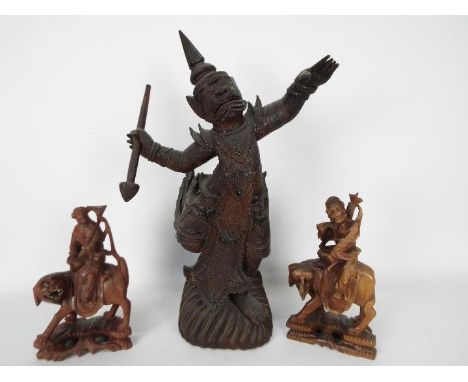 Three Asian carved wood figures, largest approximately 43 cm (h).