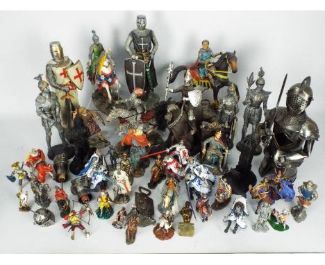 A large collection of figurines of knights, warriors, military figures, sizes vary.