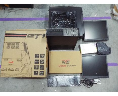 GT 1 - a mixed lot of computer equipment to include two monitors, a unused bracket, a Dell computer, keyboard, a unused and b