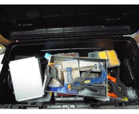 A large, hard case containing a quantity of tools, clamps, accessory organisers and similar.