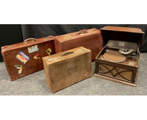 A Vintage faux crocodile leather suitcase;  another two vintage suitcases;  a 'His Master's Voice' gramophone record player, 