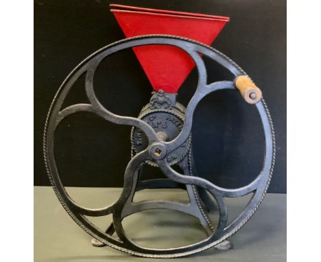 A cast iron S Nye &amp; Co, no 6 size grain or flour grinder, red hopper, 24inch diameter handle, splayed feet, cast marks, 6