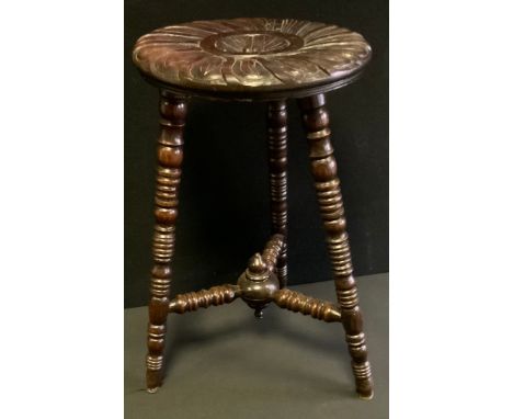 A 19th century carved oak bobbin turned stool, floral shield wheel top, turned legs, conforming stretchers, 52.5cm high, 30cm