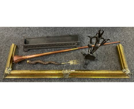 A copper hunting horn;  a novelty horn hafted toasting fork;  fire side implements;  a cast iron fender;  another brass 