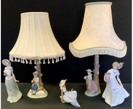 A pair of Nao figural lamps lamp, the bases with a girl and boy, printed mark;  other figures 