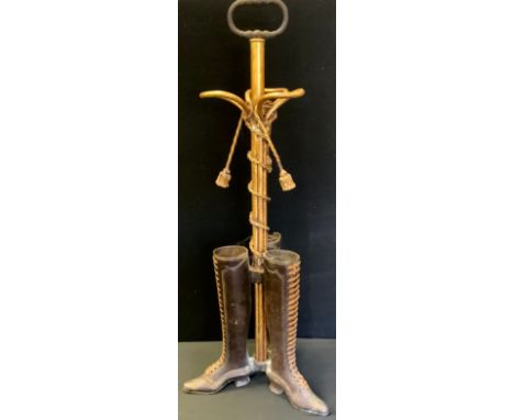 A novelty cast metal umbrella/stick stand as three boots, tassels &amp; staffs, 82cm high 