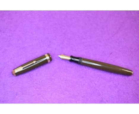 A Parker Duofold button fill fountain pen in brown with decorated broad band to cap, having a Parker Duofold N nib