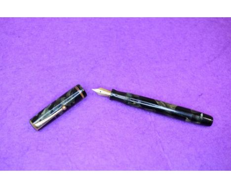 A Parker Duette Moderne button fill fountain pen in green marble with single narrow band to cap having Parker N nib. Approx 1