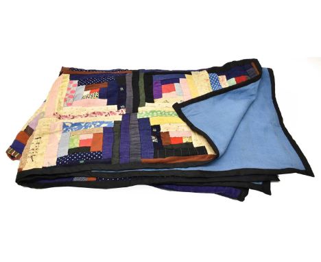 Late 19th Century Log Cabin Pattern Patchwork Quilt, comprising thrift and sheet fabric patches, using textiles from wool coa