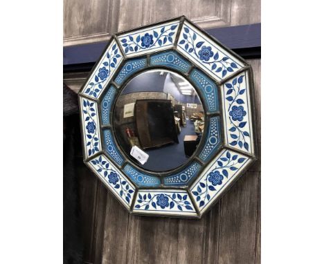 OCTAGONAL WALL MIRROR WITH PAINTED CERAMIC PANELSin a Moorish style, with floral design 