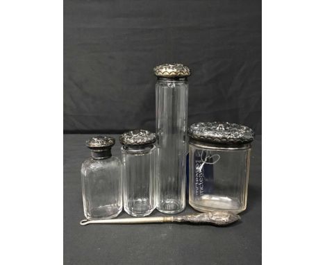 FOUR EDWARDIAN SILVER TOPPED TOILET BOTTLESalong with a silver handled button hook and a silver and mother of pearl fruit kni