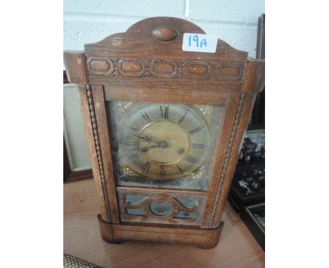 An oak framed mid 20th Century mantle clock