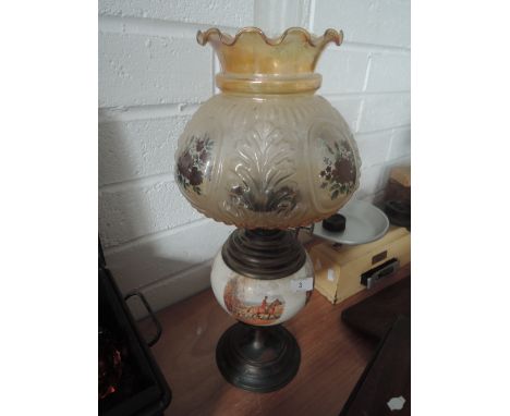 A decorative vintage oil lamp with Hunting scenes dipicted on the ceramic well and floral shade
