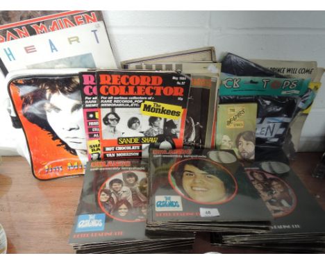 A selection of pop and rock music ephemera and souvenirs including vintage record collector magazines, calendars, light shade