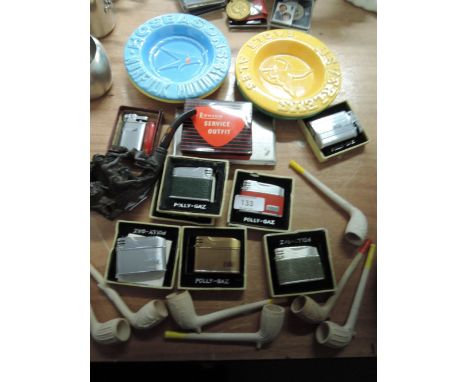 A selection of smoking related items including ornately carved pipe, collection of Poly-Gaz lighters, an engine turned cigare
