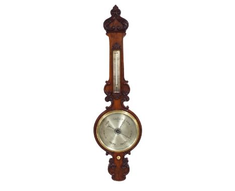 Good walnut 9.5" wheel barometer/thermometer, within a foliate carved shaped case