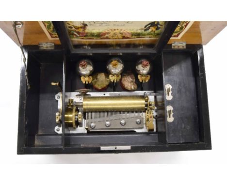 Walnut and rosewood crossbanded music box, the 6.25" cylinder playing eight airs with three butterfly hammers striking three 
