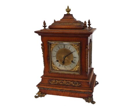 German oak two train musical bracket clock, the movement striking on a four gongs, the 6" square brass dial within a stepped 