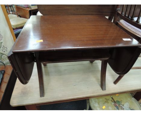 A late 20th Century occasional table having drop flaps and shelf under