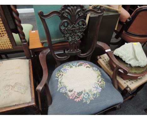 A late Victorian mahogany salon armchair having ornate pierced foliate slat back, over tapestry seat and cabriole frome