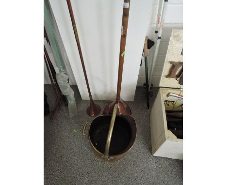 A copper post horn, poss stick and a brass coal helmet