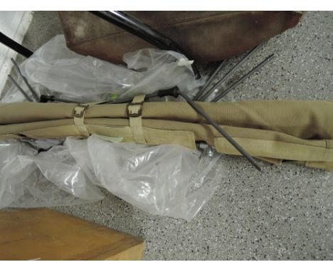 A khaki army style fold away camping bed.